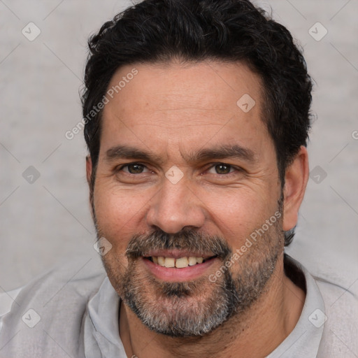 Joyful white adult male with short  black hair and brown eyes