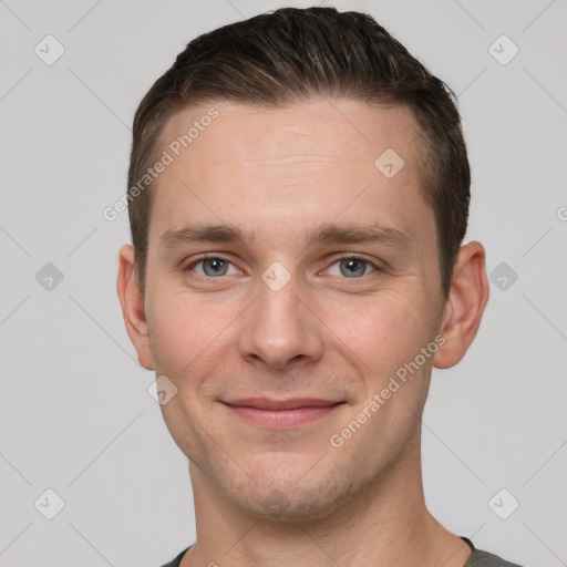 Joyful white young-adult male with short  brown hair and grey eyes