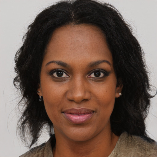 Joyful black young-adult female with medium  brown hair and brown eyes