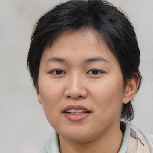 Joyful asian young-adult female with medium  brown hair and brown eyes
