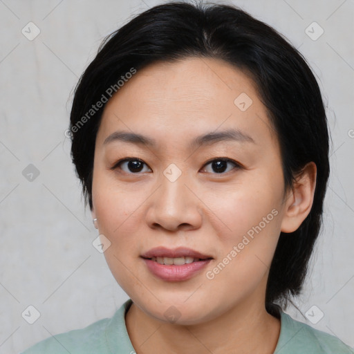 Joyful asian young-adult female with medium  black hair and brown eyes