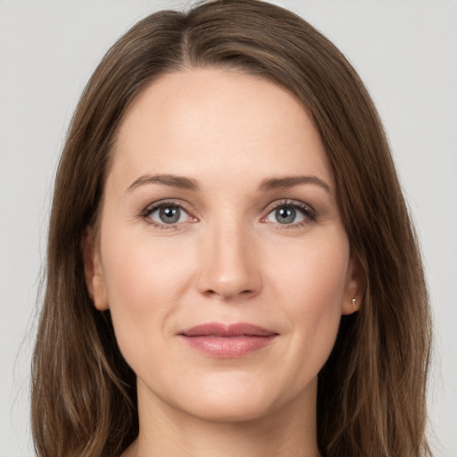 Joyful white young-adult female with long  brown hair and grey eyes