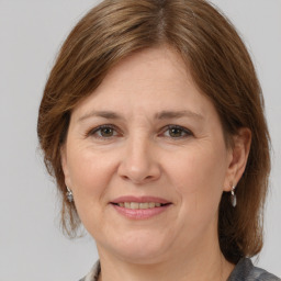 Joyful white adult female with medium  brown hair and grey eyes