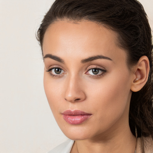 Neutral white young-adult female with long  brown hair and brown eyes