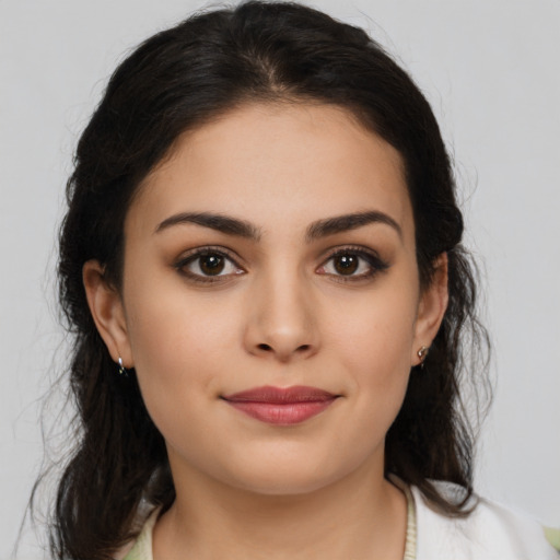 Joyful latino young-adult female with medium  brown hair and brown eyes