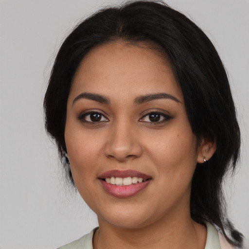 Joyful latino young-adult female with medium  black hair and brown eyes