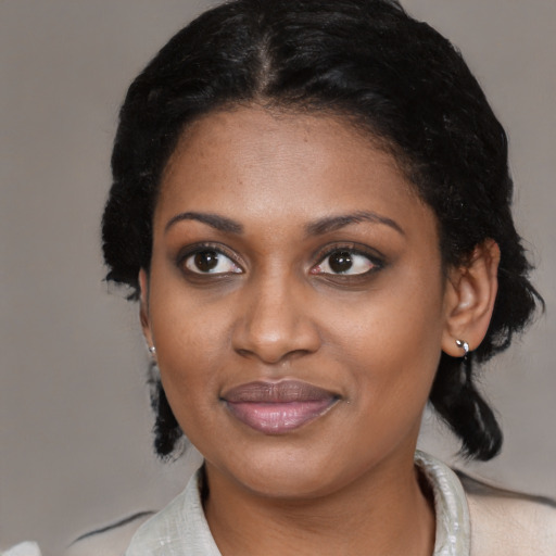 Joyful black young-adult female with medium  black hair and brown eyes
