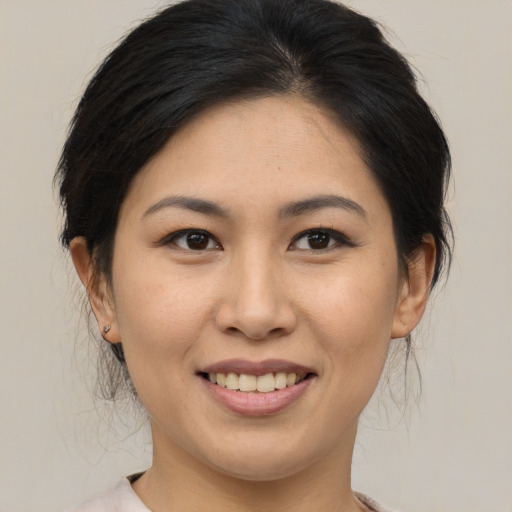 Joyful asian young-adult female with medium  brown hair and brown eyes