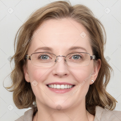 Joyful white adult female with medium  brown hair and blue eyes