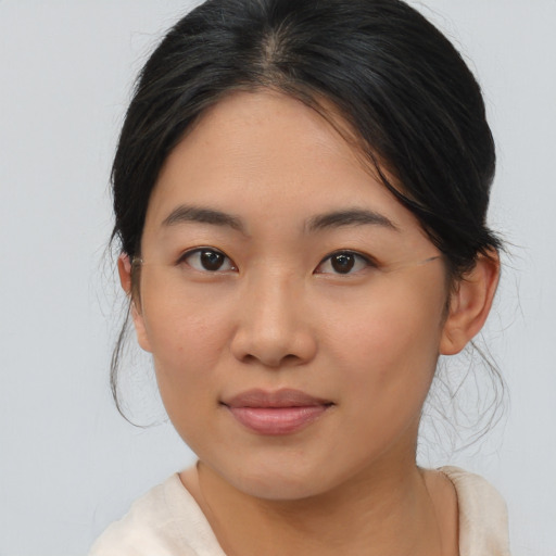Joyful asian young-adult female with medium  brown hair and brown eyes