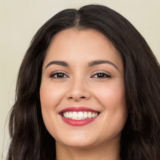 Joyful white young-adult female with long  brown hair and brown eyes