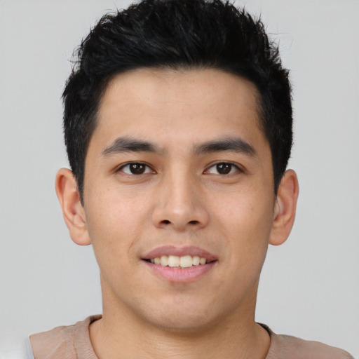 Joyful asian young-adult male with short  brown hair and brown eyes