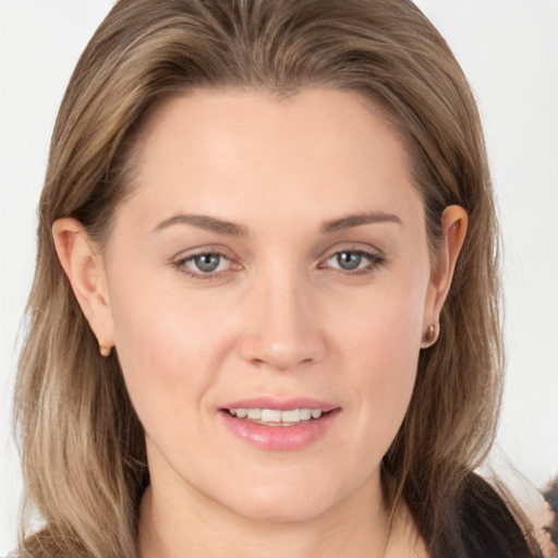 Joyful white young-adult female with long  brown hair and grey eyes