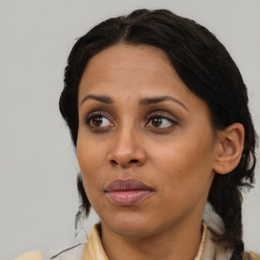 Joyful black adult female with medium  black hair and brown eyes