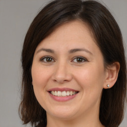 Joyful white young-adult female with medium  brown hair and brown eyes