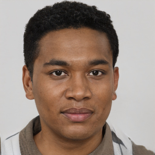Joyful black young-adult male with short  black hair and brown eyes