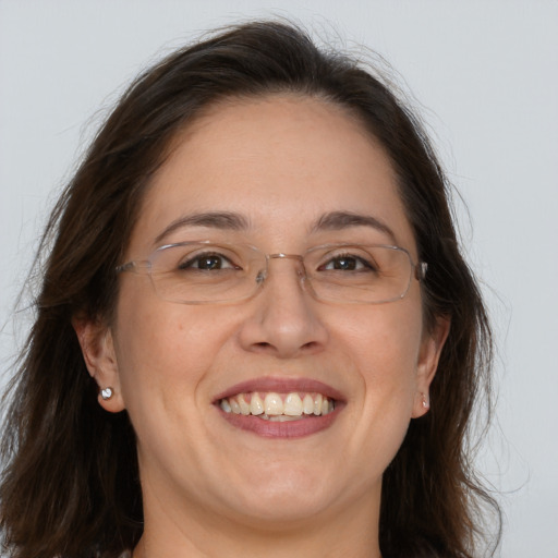 Joyful white adult female with medium  brown hair and brown eyes