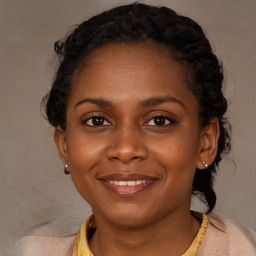 Joyful black young-adult female with long  brown hair and brown eyes