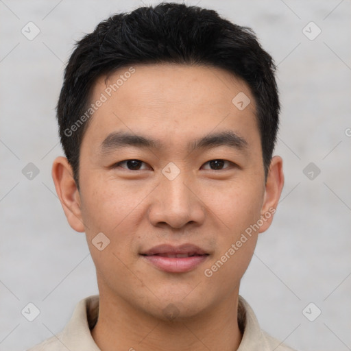 Joyful asian young-adult male with short  black hair and brown eyes