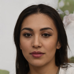 Joyful latino young-adult female with medium  brown hair and brown eyes