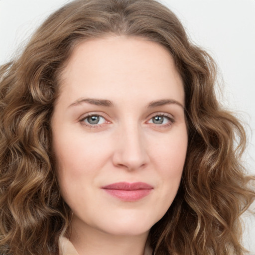 Joyful white young-adult female with long  brown hair and green eyes