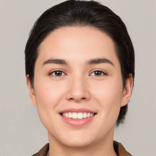 Joyful white young-adult female with medium  brown hair and brown eyes