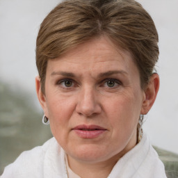 Joyful white adult female with short  brown hair and grey eyes