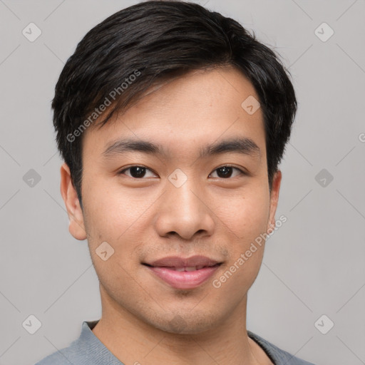 Joyful asian young-adult male with short  black hair and brown eyes