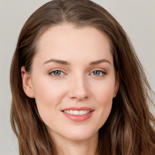 Joyful white young-adult female with long  brown hair and grey eyes