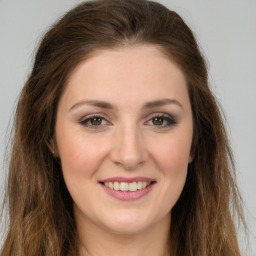 Joyful white young-adult female with long  brown hair and green eyes