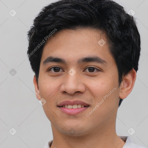 Joyful asian young-adult male with short  brown hair and brown eyes