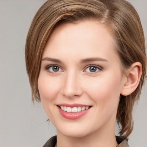 Joyful white young-adult female with medium  brown hair and grey eyes