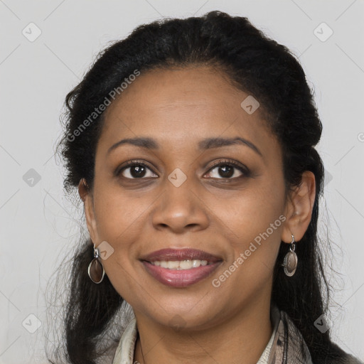 Joyful black young-adult female with long  brown hair and brown eyes