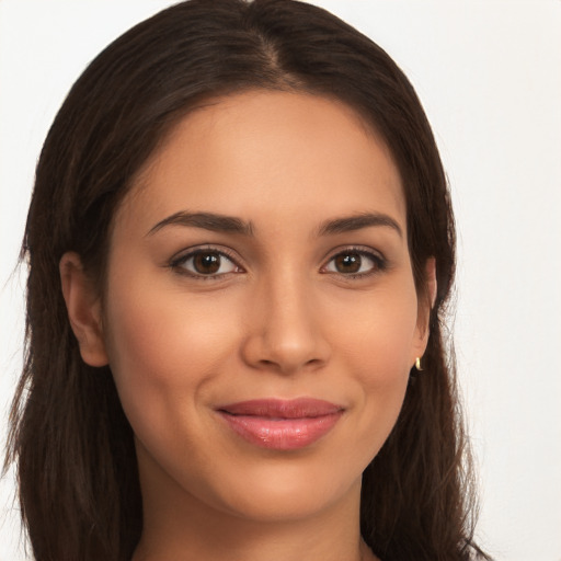 Joyful latino young-adult female with long  brown hair and brown eyes