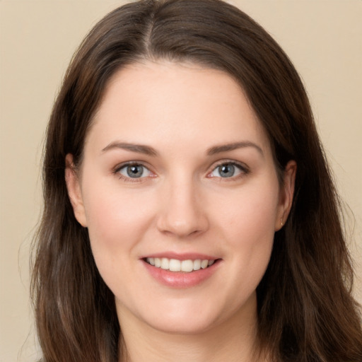 Joyful white young-adult female with long  brown hair and brown eyes