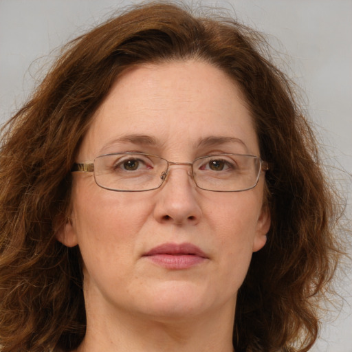 Joyful white adult female with long  brown hair and green eyes