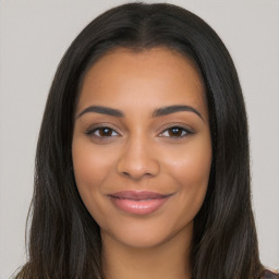 Joyful latino young-adult female with long  brown hair and brown eyes