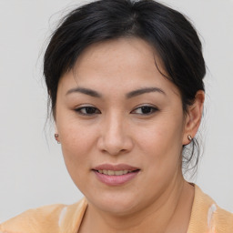 Joyful asian young-adult female with medium  brown hair and brown eyes