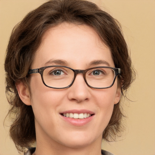 Joyful white young-adult female with medium  brown hair and green eyes