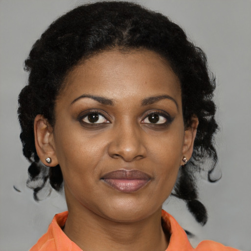 Joyful black young-adult female with medium  brown hair and brown eyes