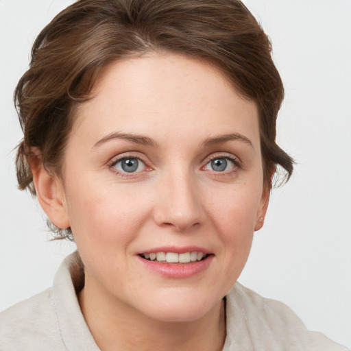 Joyful white young-adult female with short  brown hair and grey eyes