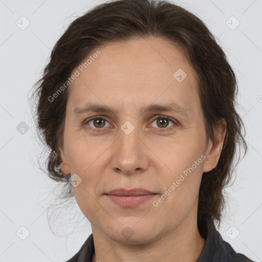 Joyful white adult female with medium  brown hair and brown eyes