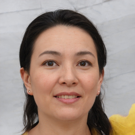 Joyful white adult female with medium  brown hair and brown eyes