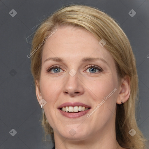 Joyful white adult female with medium  brown hair and blue eyes