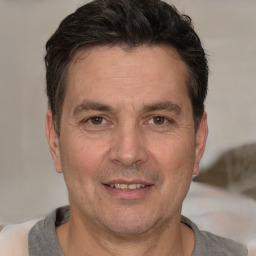 Joyful white adult male with short  brown hair and brown eyes