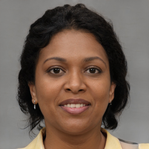 Joyful black young-adult female with medium  brown hair and brown eyes