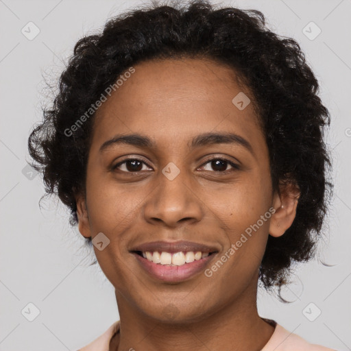 Joyful black young-adult female with long  brown hair and brown eyes