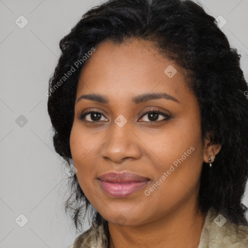 Joyful black young-adult female with long  black hair and brown eyes