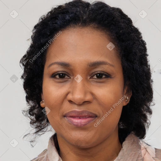 Joyful black adult female with medium  brown hair and brown eyes