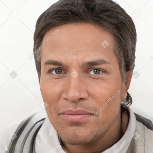 Joyful white adult male with short  brown hair and brown eyes